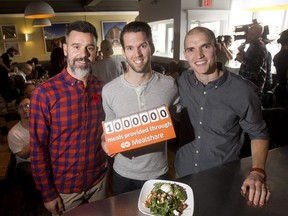 Shayne Perrin, owner of Blue Star Diner, left, joins the Mealshare founders Andrew Hall, centre, and Jeremy Bryant in celebrating the 1 millionth meal served for the charity Tuesday November 1, 2016. Selected menu items help Mealshare feed the needy. Blue Star was the first restaurant to sign on to the program.