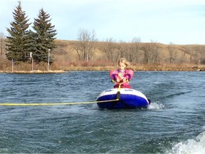 Three year old Vivienne Denis water skis, in a water skiing trainer, at Predator Bay Water ski Club on Saturday November 5, 2016 south of Calgary.  The youngest ever to ski at the site in November. The weekend marked the first time the site had been skied in November by anyone adult or child alike. (Supplied/Postmedia Calgary )