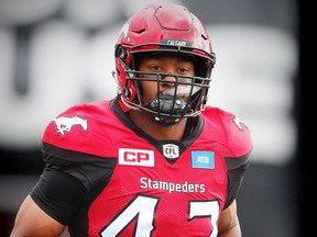 Calgary Stampeders Deron Mayo runs onto the field during player introductions before facing the Ottawa Redblacks in CFL football in Calgary, Alta., on Saturday, September 17, 2016. AL CHAREST/POSTMEDIA