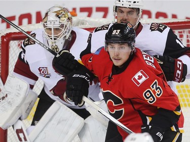 Sam Bennett of the Calgary Flames crowds the net of Arizona Coyotes goalie Mike Smith and defenseman Brad Richardson during the first period at the Saddledome Wednesday November 16, 2016.