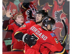 Michael Frolik of the Calgary Flames celebrates with captain Mark Giordano after scoring the winning goal in overtime against the Arizona Coyotes at the Saddledome Wednesday November 16, 2016.