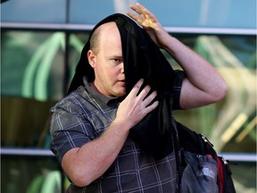 Robert Nicholson leaves the Calgary Courts Centre on Thursday April 10, 2014 after he pleaded guilty to one count of causing harm to an animal. Leah Hennel/Postmedia