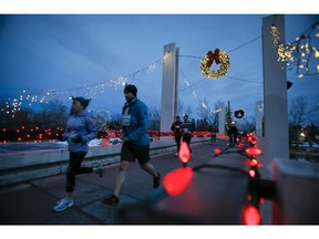 Runners cross Prince's Island Bridge in downtown Calgary. Our parks and pathways help build a strong, healthy community, writes guest columnist Myrna Dube.