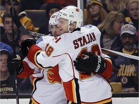 Calgary Flames' Sam Bennett (93) celebrates his goal with teammate Matt Stajan (18) during the first period of an NHL hockey game against the Boston Bruins in Boston, Friday, Nov. 25, 2016.