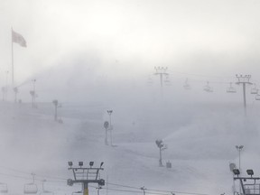 Snow-making operations at Canada Olympic Park shroud the ski hill in an eerie mist Friday, Nov. 18, 2016.