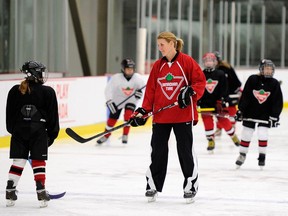 Olympic hockey player Hayley Wickenheiser shares her love of the game with young girls at Wickfest in Calgary.