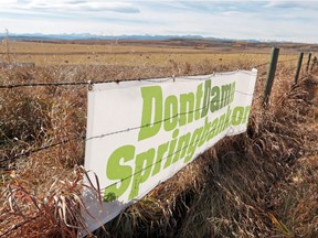 Signs supporting the DontDamnSpringbank.org movement are posted on fences along Springbank Road on October 17, 2014.