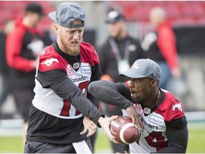 Calgary Stampeders quarterback Bo Levi Mitchell (19) hands off to Calgary Stampeders running back Roy Finch (14) during the Western Conference practice, in Toronto on Saturday, November 26, 2016. Calgary plays the Ottawa Redblacks in the 104th Grey Cup game Sunday Nov. 27, 2016.