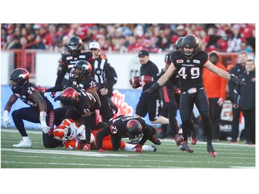 Calgary Stampeders Alex Singleton celebrates after a stopping Jeremiah Johnson of the BC Lions during 2016 CFLís West Division Final in Calgary, Alta., on Sunday, November 20, 2016. AL CHAREST/POSTMEDIA