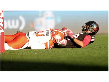 Calgary Stampeders Marquay McDaniel makes a touchdown as BC Lions Mike Edem tries to stop him during CFL Western Final action at McMahon Stadium in Calgary, Alta.. on Sunday November 20, 2016. Leah hennel/Postmedia