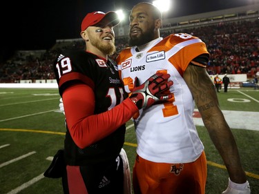 Calgary Stampeders quarterback Bo Levi Mitchell, left, greets BC Lions Emmanuel Arceneaux after the Western Final CFL action at McMahon Stadium in Calgary, Alta.. on Sunday November 20, 2016. Leah hennel/Postmedia