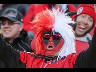 A fan urges on the Calgary Stampeders against the BC Lions in Western Final CFL action at McMahon Stadium in Calgary, Alta.. on Sunday November 20, 2016. The Stamps beat the Lions 42-15. Mike Drew/Postmedia