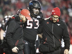 Calgary Stampeders Brad Erdos is helped off the field during a game in the 2016 CFLís West Division Final in Calgary, Alta., on Sunday, November 20, 2016. AL CHAREST/POSTMEDIA