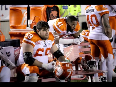 BC Lions Charles Vaillancourt and Adrian Clarke watch the time run out against the Calgary Stampeders in Western Final CFL action at McMahon Stadium in Calgary, Alta.. on Sunday November 20, 2016. The Stamps beat the Lions 42-15. Mike Drew/Postmedia