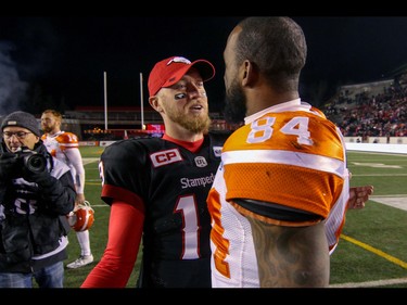 BC Lions Emmanuel Arceneaux talks with Calgary Stampeders Bo Levi Mitchell  in Western Final CFL action at McMahon Stadium in Calgary, Alta.. on Sunday November 20, 2016. The Stamps beat the Lions 42-15. Mike Drew/Postmedia