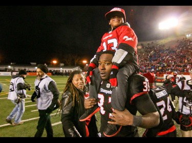 Calgary Stampeders Jerome Messam with son Xavier, 5,  and wife Tamika celebrate the Stamps win over the BC Lions  in Western Final CFL action at McMahon Stadium in Calgary, Alta.. on Sunday November 20, 2016. The Stamps beat the Lions 42-15. Mike Drew/Postmedia