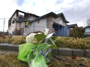 A single bouquet of flowers rest on the front lawn of a home on Sunday November 6, 2016 in northeast Calgary, Alta destroyed by fire early Saturday morning. One person died in the fire and three others were taken to hospital . Jim Wells//Postmedia