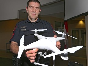 Calgary Police Service traffic Section Sgt Colin Foster displays an unmanned aerial vehicle (drone) as he starts a public information session in Calgary, Alta on Saturday November 19, 2016. Foster reminds citizens that it is illegal to fly within the law and regulations. Jim Wells//Postmedia