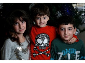 Syrian refugees Kailen Darmo, 8, David Darmo, 11, and little brother Ralph, 4, at their new home in Calgary, Alta., on Saturday November 19, 2016.