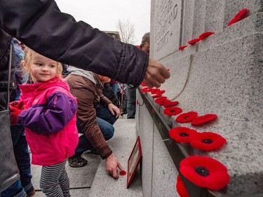 The crowds surges forward to lay their poppies on the cenotaph at Central Memorial Park after the Remembrance Day ceremonies in Calgary, Ab., on Friday November 11, 2016.