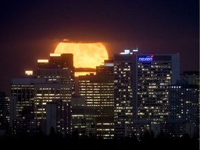 The supermoon rises behind downtown Calgary, Alta., on Monday, Nov. 14, 2016.