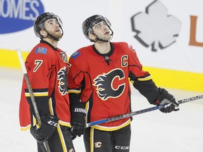 TJ Brodie and Mark Giordano of the Calgary Flames watch a video replay of a Anaheim Ducks  goal in Calgary, Alta., on Monday, Feb. 15, 2016. Lyle Aspinall/Postmedia Network