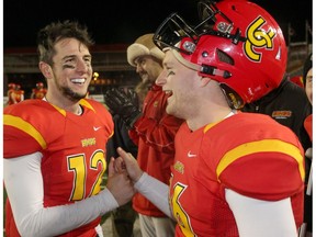 UofC Dinos Adam Sinagra and Jimmy Underdahl celebrate their win over St. Francis X-Men in Mitchell Bowl action at McMahon Stadium in Calgary, Alta.. on Saturday November 19, 2016. The Dinos beat the X-Men 50-24.