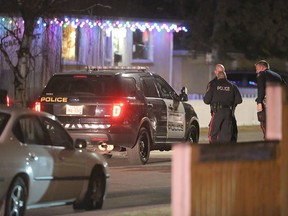 Calgary police officers guard the scene of a shooting that took place around 9:30 p.m. Saturday, Nov. 26, 2016, at a home near 19 Ave. and 30 St. S.E.