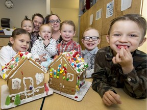 Dad Ben Oosterhoff and mom Angel Nagy sit with their kids (L-R) Jordan Oosterhoff, 9, Jacob Charles, 4, Emma Nagy, 2, Nathan Oosterhoff, 3, Keegan Doye, 7, and Mason Charles, 6, after making gingerbread houses at CUPS (Calgary Urban Project Society) in downtown Calgary, Alta., on Thursday, Nov. 17, 2016. CUPS, an agency helping families and people in need, is one of the recipients in this year's Herald Christmas Fund.