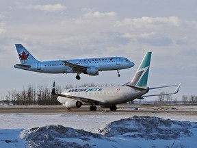FILE PHOTO: EDMONTON, AB: January 15, 2013 — Air Canada jet coming in for a landing as a Westjet gets ready to take off at the Edmonton International Airport, January 15, 2013.