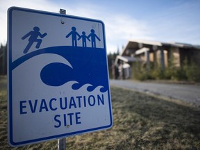 FILE PHOTO: A tsunami evacuation site sign is shown on high ground near the House of Huuayaht in the village of Anacla in Pachena Bay, B.C. Wednesday, Jan. 14, 2015. When the next megathrust quake hits, residents on the west side of Vancouver Island will barely have 20 minutes to get to higher ground. THE CANADIAN PRESS/Jonathan Hayward
