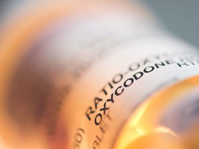 Prescription pill bottle containing oxycodone and acetaminophen are shown in this June 20, 2012 photo.