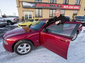 General Manager Chris Thin stands with a 2010 Dodge Charger SXT AWD at the Automaxx on 6 St NE in Calgary, Alta., on Monday, Dec. 5, 2016. The car is going to a man who was caught on video riding a scooter down the QEII highway in harsh, snowy weather the day before. Lyle Aspinall/Postmedia Network