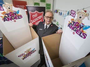Lt. Col. Larry Martin of the Salvation Army poses for a photo with empty Toy Angels boxes at YouthLink in Calgary, Alta., on Saturday, Dec. 10, 2016. Salvation Army is low on donations for its annual Toy Angels campaign, which runs until Dec. 23. Donations can be dropped off at IKEA, Marlborough Mall, Westbrook Mall, any Calgary Police Services station and any CIR Realty office. Lyle Aspinall/Postmedia Network