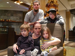 Mom Laura Hudson with son Keagan, daughter Micah, son Terrance and husband Nathan in Calgary, Ab., on Saturday December 3, 2016. The Medicine Hat family is pleading with thieves who broke into their Calgary motel room and stole Laura's purse that had their recently-deceased baby’s ashes inside. They were in town for a tree lighting ceremony for babies that have passed away. Mike Drew/Postmedia