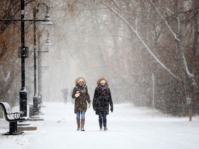 Kathrin Smith, left and Jen De Minico enjoy the snowy weather in Calgary on Sunday, Dec. 4, 2016.