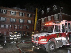 Fire personnel gather for a briefing outside the Mount Royal Hotel. Fire crews from Banff, Canmore, Exshaw and Lake Louise responded to an early morning downtown fire on the roof of the historic property on Thursday, Dec. 29, 2016.