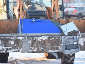 A man is in custody after a front end loader was used to crash through a north Edmonton CashCo storefront and steal an ATM.