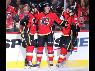 The Calgary Flames' Mikael Backlund, centre, celebrates his first period goal on the Anaheim Ducks with teammates Michael Frolik, left and Matthew Tkachuk during the NHL action at the Scotiabank Saddledome in Calgary on Thursday December 29, 2016.
