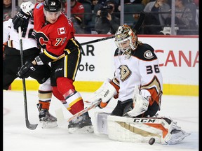 Calgary Flames forward Micheal Ferland tries  to get the puck past Anaheim Ducks goaltender John Gibson in Calgary on Thursday December 29, 2016.