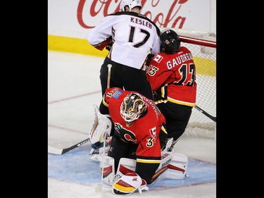 The Anaheim Mighty Ducks' Ryan Kesler knocks down Calgary Flames forward Johnny Gaudreau during their NHL game at the Scotiabank Saddledome in Calgary on Thursday December 29, 2016.