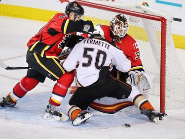 Calgary Flames goaltender Chad Johnson couldn't quite get his glove on this loose puck as Flames captain Mark Giordano puts the pressure on the Anaheim Mighty Ducks' Antoine Vermette at the Scotiabank Saddledome in Calgary on Thursday December 29, 2016. The Ducks scored on while on the third period power play.