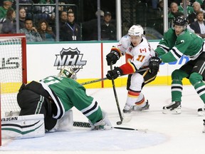 Calgary Flames center Mikael Backlund (11) of Sweden attempts to get the puck into the net past Dallas Stars' Antti Niemi (31) of Finland as John Klingberg (3) of Sweden helps defend against the shot in the second period of an NHL hockey game, Monday, Jan. 25, 2016, in Dallas.