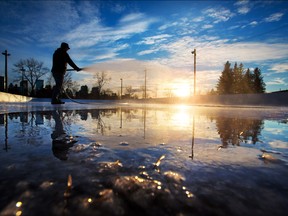 Volunteer Tim Edwards floods the North Hill Curling Club's outdoor rink in Crescent Heights on Monday December 5, 2016. After a warm few months the start of cold weather has allowed outdoor rinks the chance to create ice.