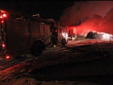 Calgary firefighters extinguish a fire in a mobile home at the Midfield Mobile Home Park on Wednesday evening December 7, 2016.