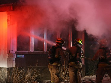 Calgary firefighters extinguish a fire in a mobile home at the Midfield Mobile Home Park on Wednesday evening December 7, 2016.