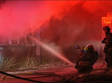 Calgary firefighters extinguish a fire in a mobile home at the Midfield Mobile Home Park on Wednesday evening December 7, 2016.