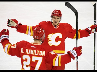 Calgary Flames Mikael Backlund and Dougie Hamilton celebrate Hamilton's second goal of the game against the Winnipeg Jets during the second period of NHL action at the Scotiabank Saddledome in Calgary on Saturday December 10, 2016. Backlund assisted on the goal.