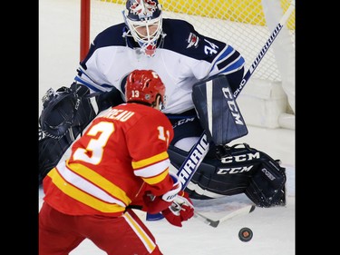 Calgary Flames forward Johnny Gaudreau goes in on  Winnipeg Jets goaltender Michael Hutchinson during the second period of NHL action at the Scotiabank Saddledome in Calgary on Saturday December 10, 2016.