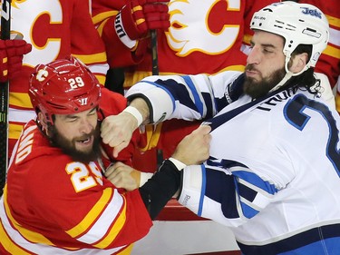 The Calgary Flames' Deryk Engelland and the Winnipeg Jets forward Chris Thorburn fight during their NHL game at the Scotiabank Saddledome in Calgary on Saturday December 10, 2016.